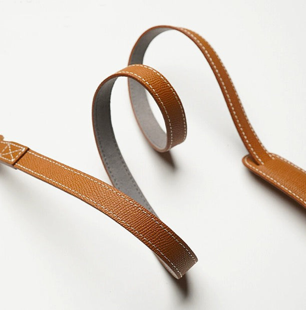 Brown strap with DSLR camera outdoors