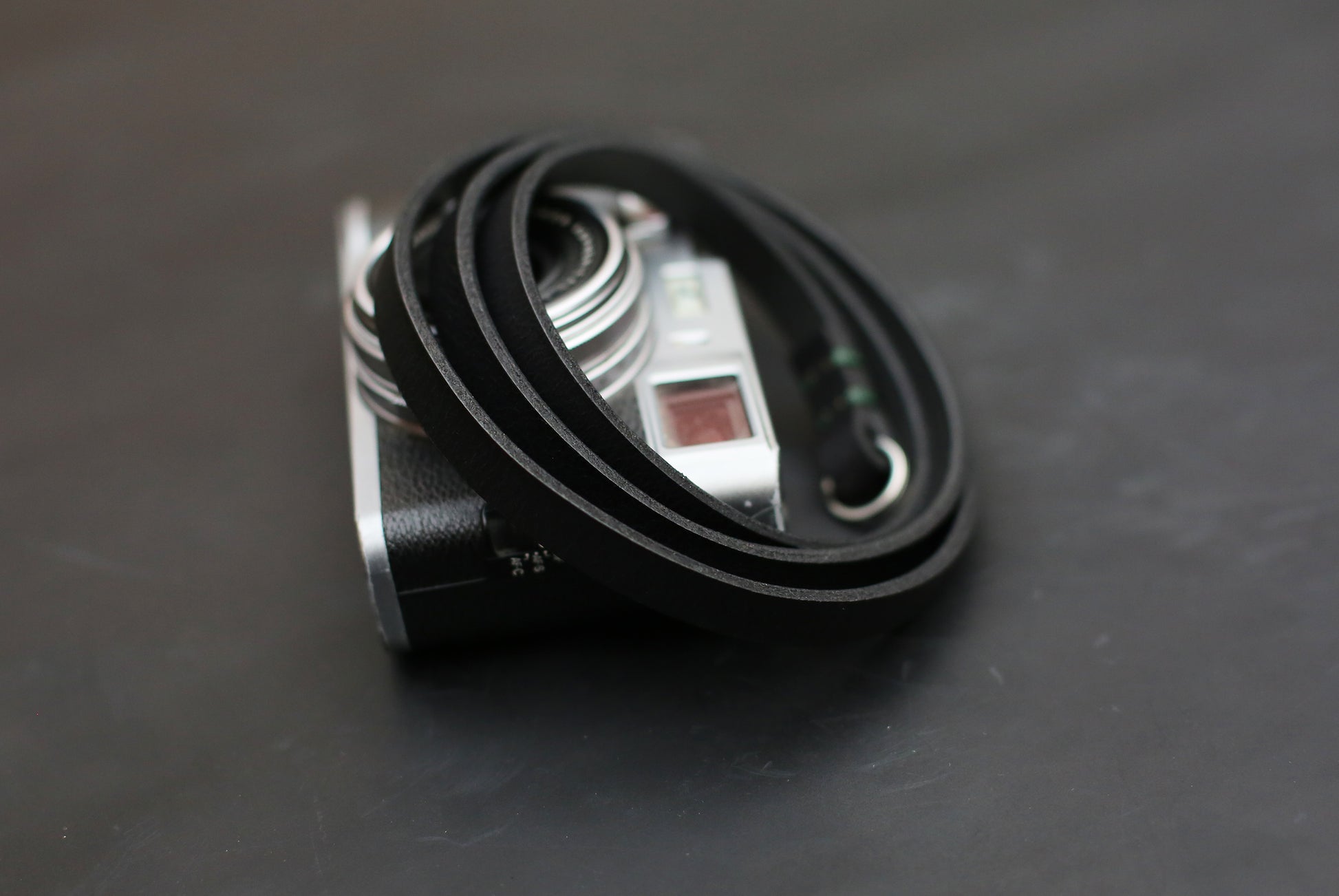 Elegant black leather camera strap with durable stitching and smooth finish