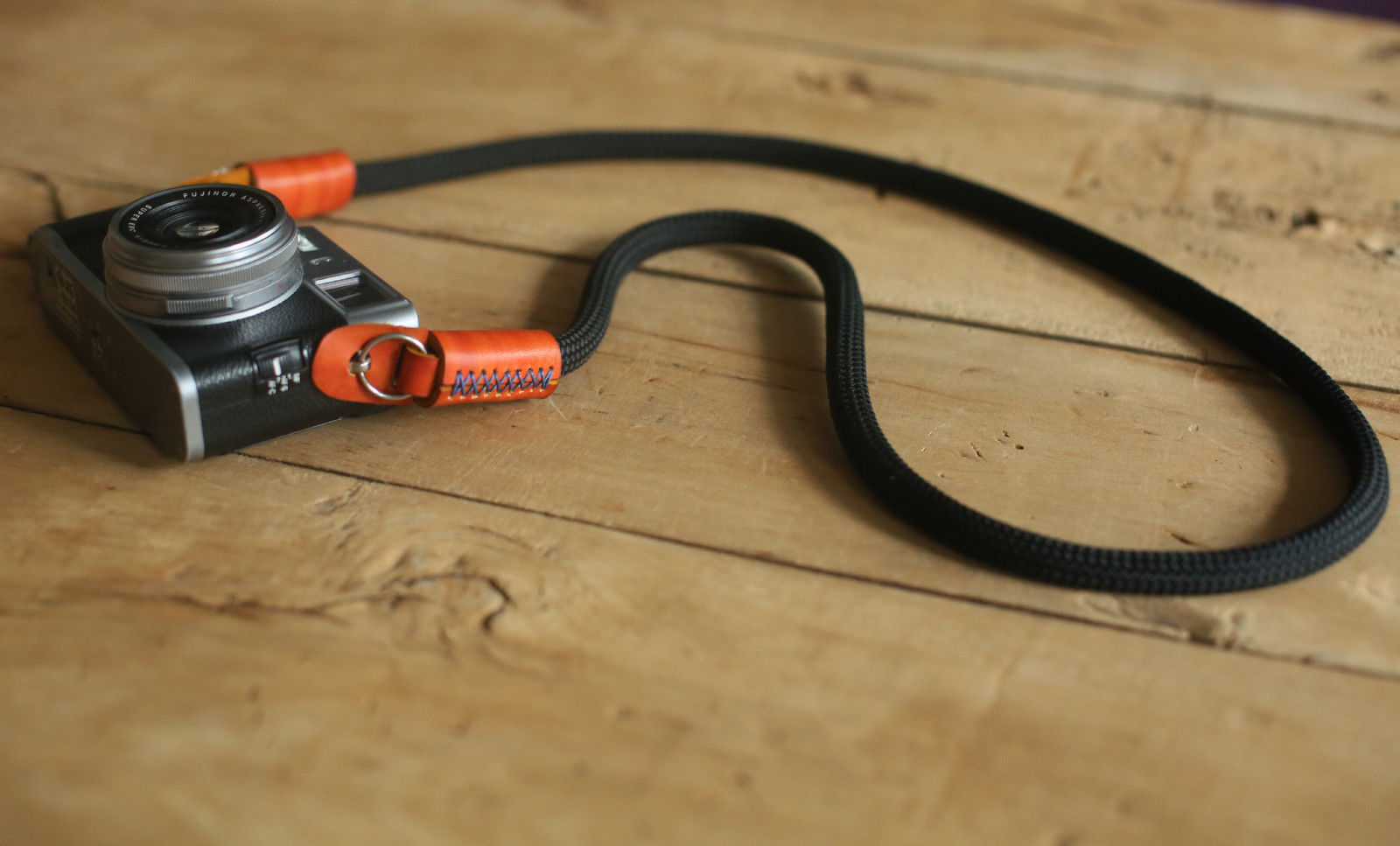 black handmade camera strap flat lay