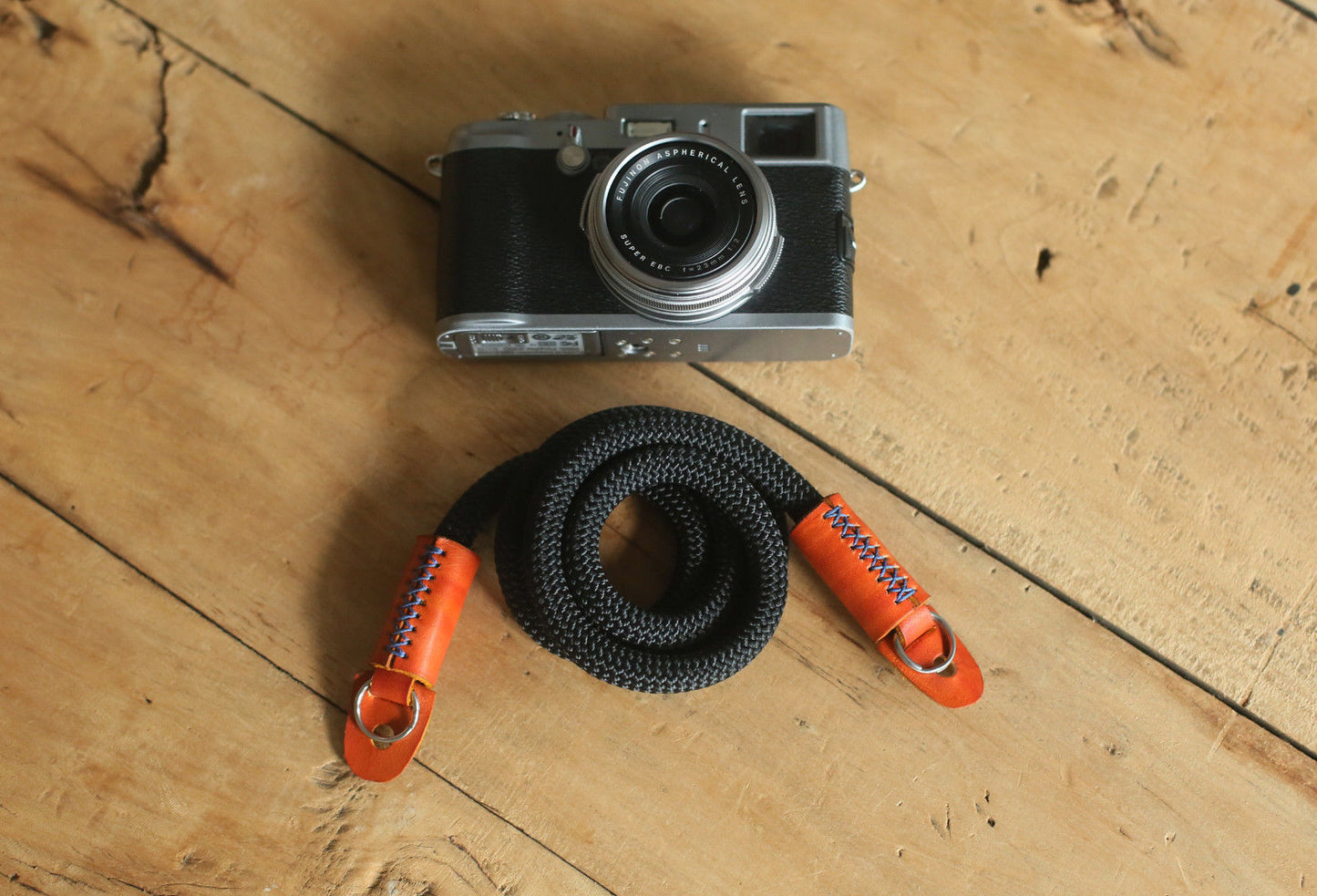 handcrafted camera strap on wooden desk