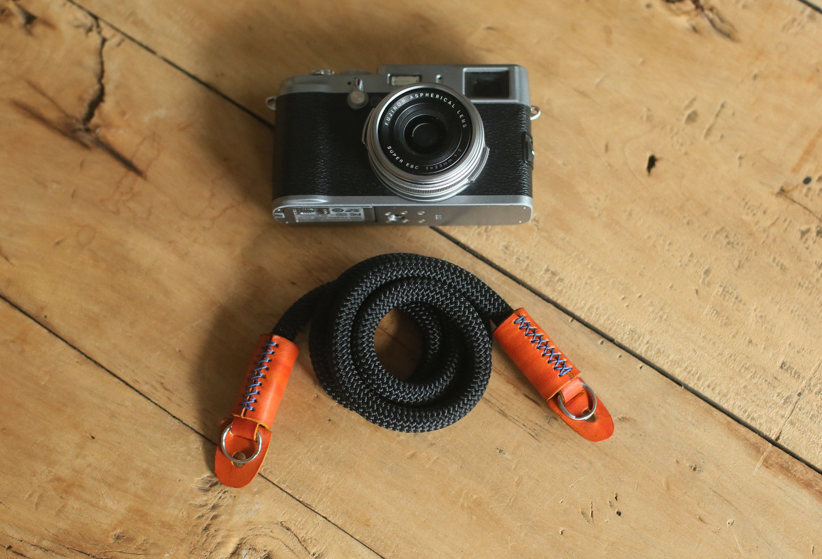 handcrafted camera strap on wooden desk