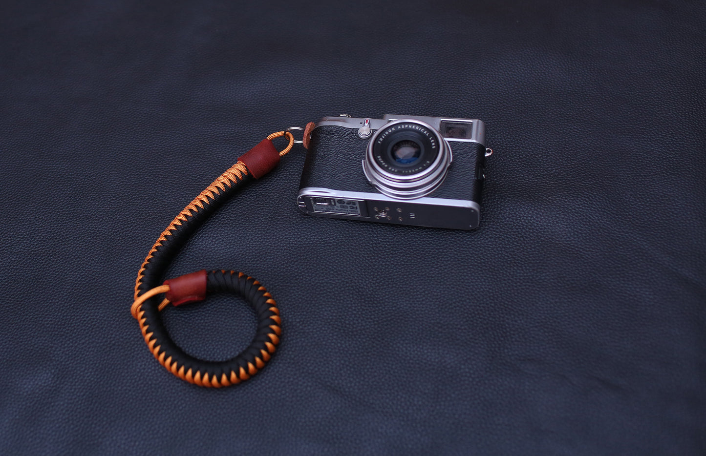Black & gold paracord camera wrist strap with pebbled leather ends