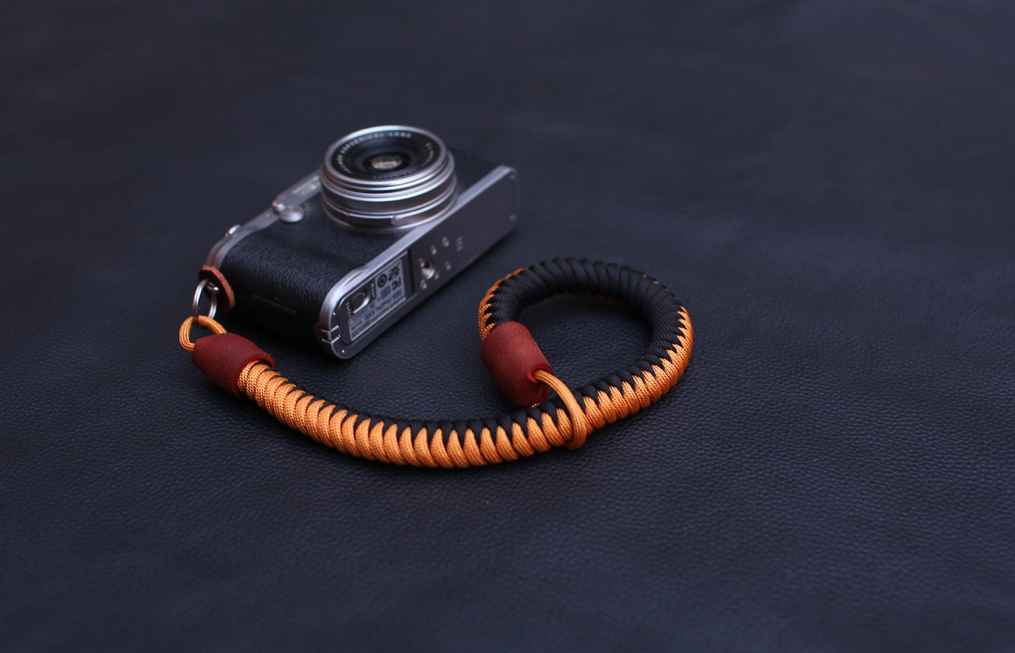 Close-up of stitched leather end and metal split ring attachment