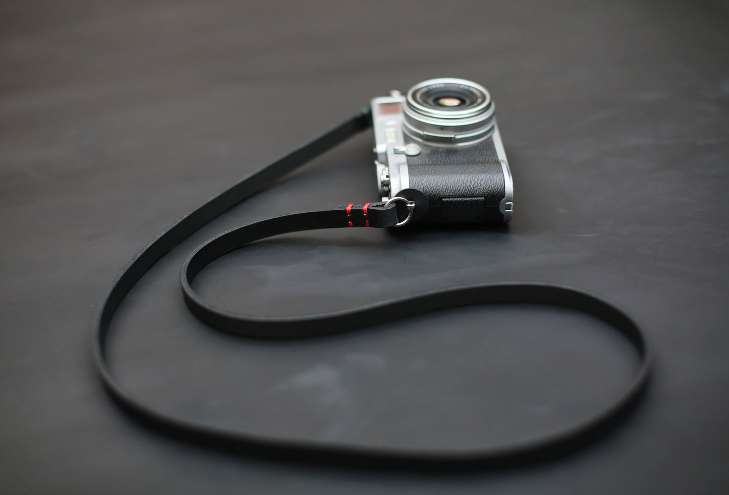 Handmade black buffalo leather camera strap, 10mm wide, minimalist design for mirrorless and film cameras