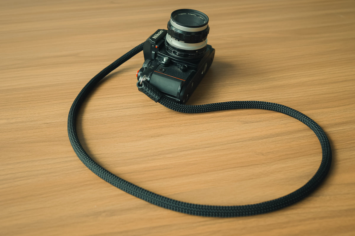 Close-up detail of 10mm black climbing rope camera strap
