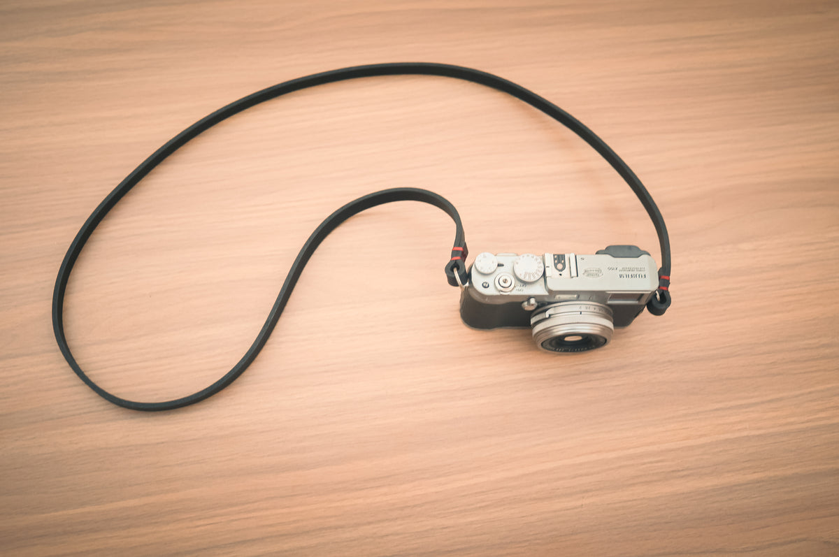 Close-up of the 10mm-wide black leather camera strap