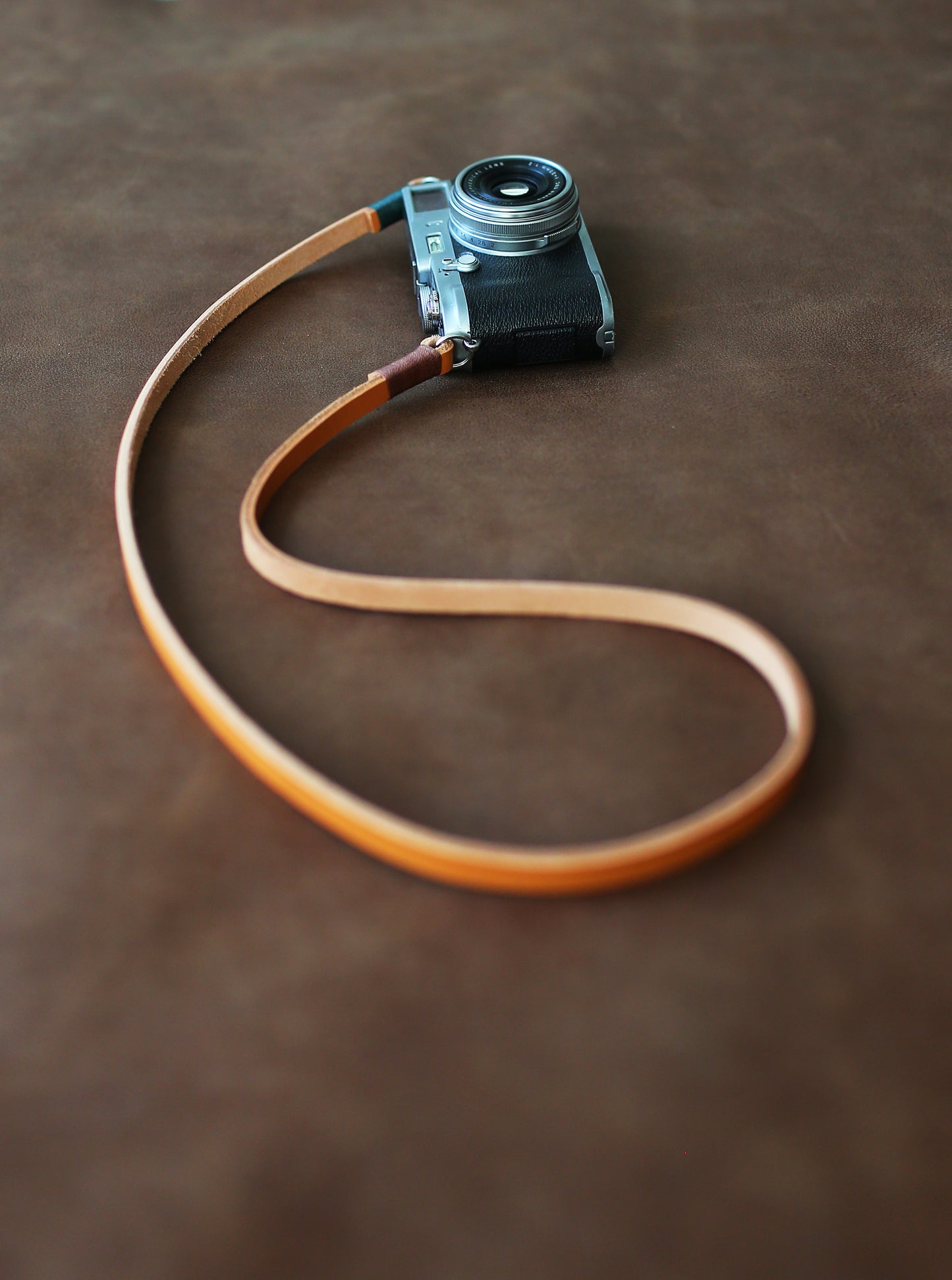 Light brown handmade leather camera strap on vintage camera
