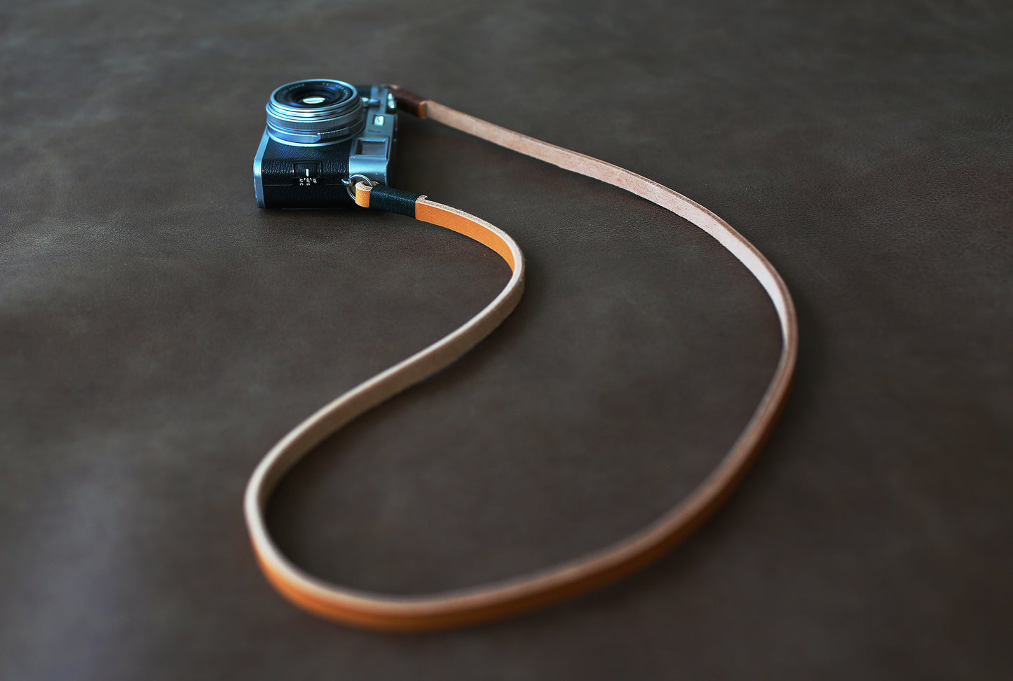 Model wearing handmade camera neck strap outdoors windmup