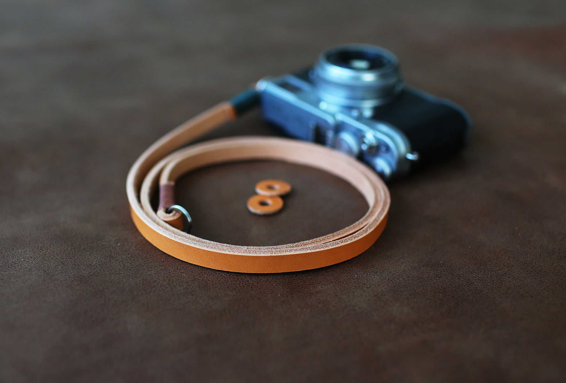 Light brown handmade leather camera strap on vintage camera film camera
