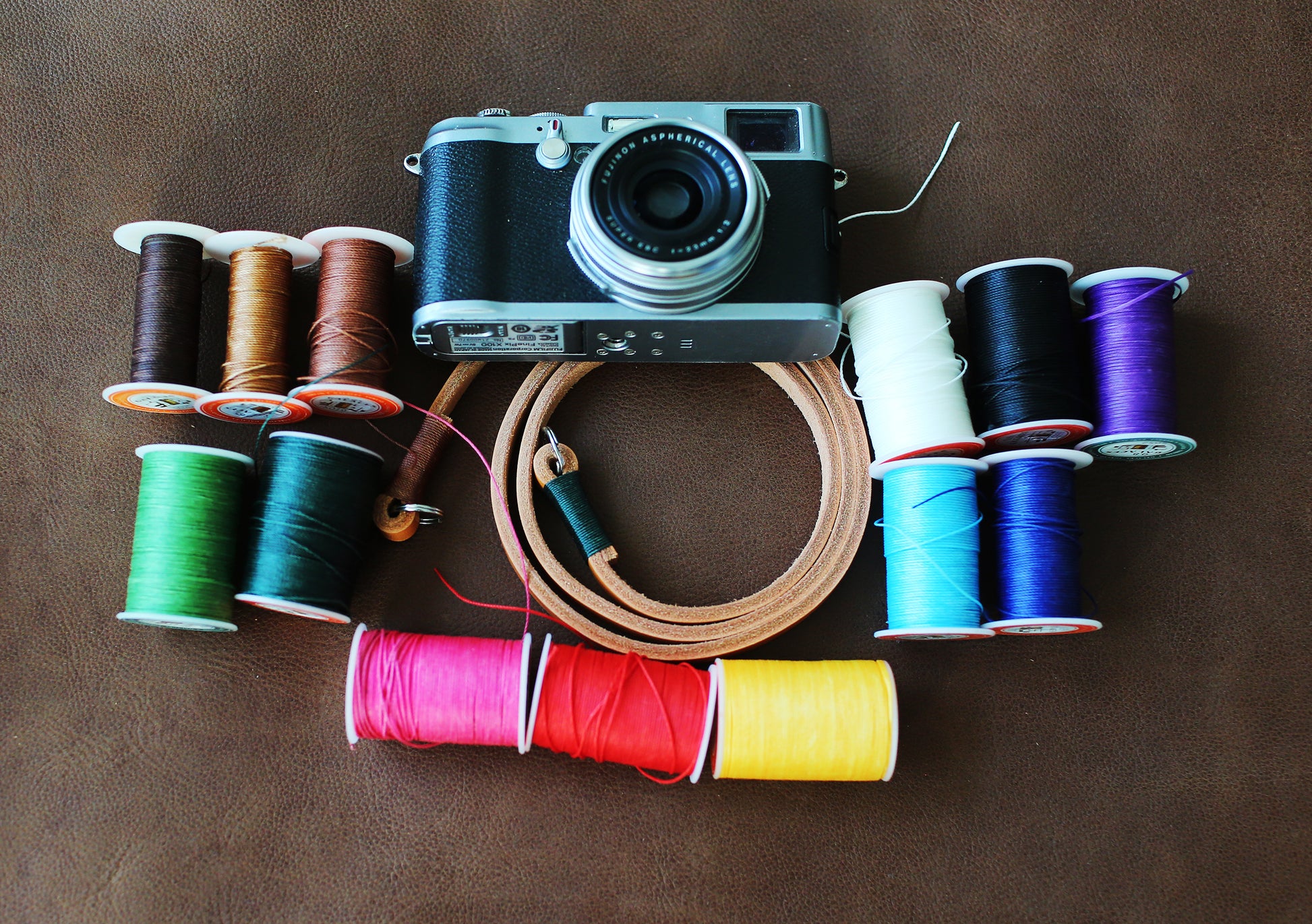 Light brown handmade leather camera strap on vintage camera film