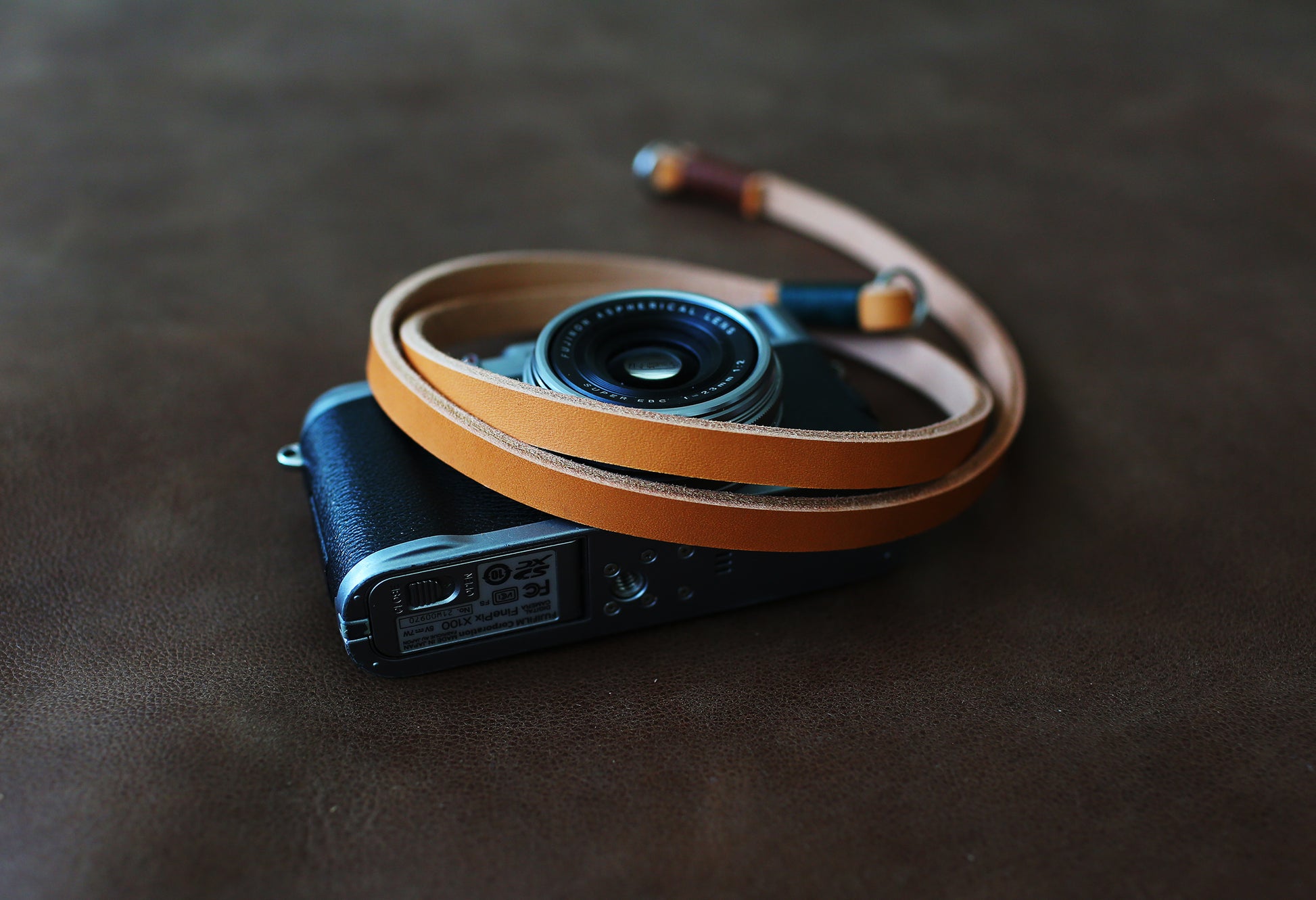 Light brown handmade leather camera strap on vintage camera