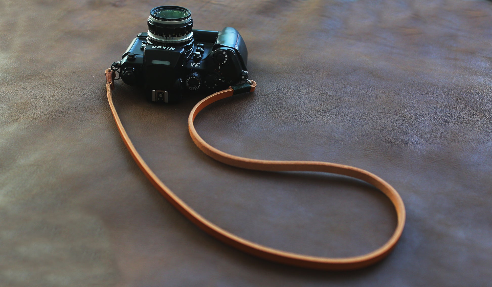 Light brown handmade leather camera strap on vintage camera film camera 