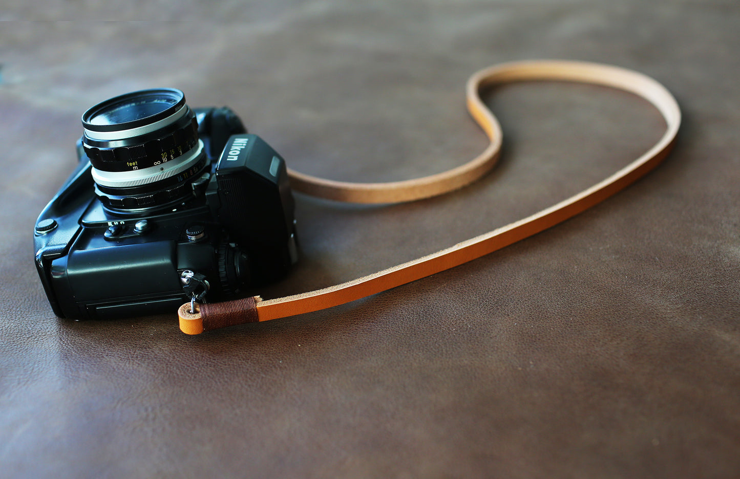 Light brown handmade leather camera strap on vintage camera