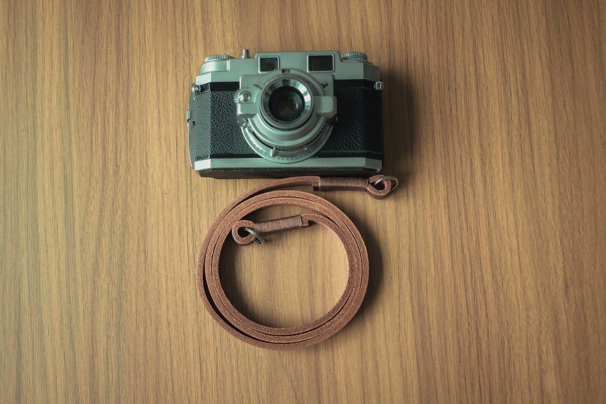 Adjustable brown leather camera strap with classic vintage style