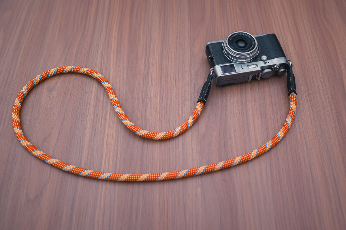 Adjustable orange and gold camera strap available in 70–125cm lengths