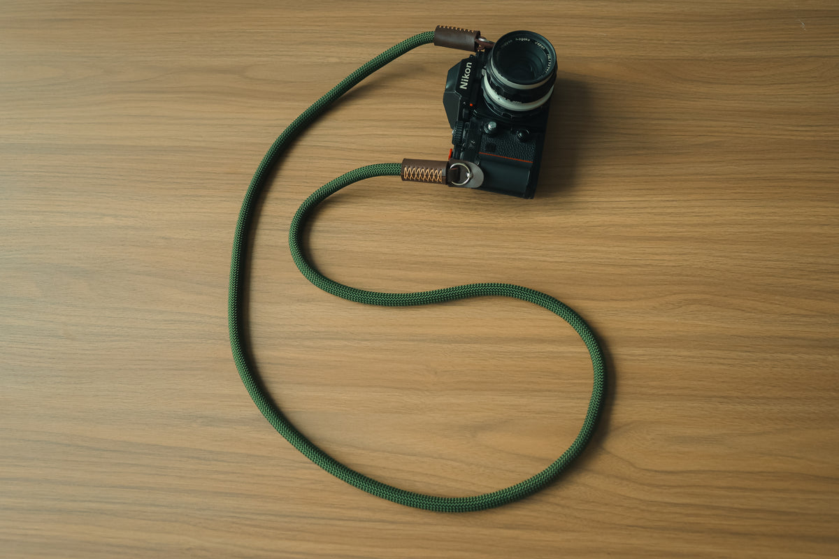 Army green rope and tan leather camera strap