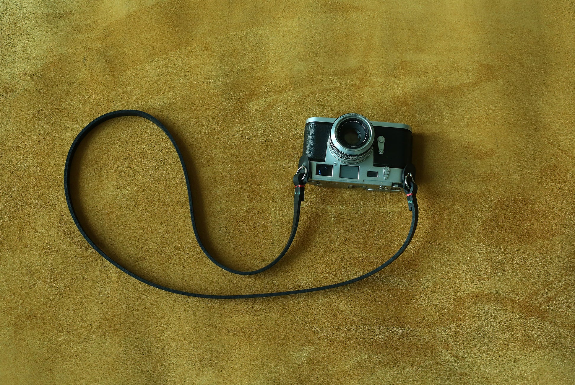 High-quality black leather strap for film photography with a discrete stealth look