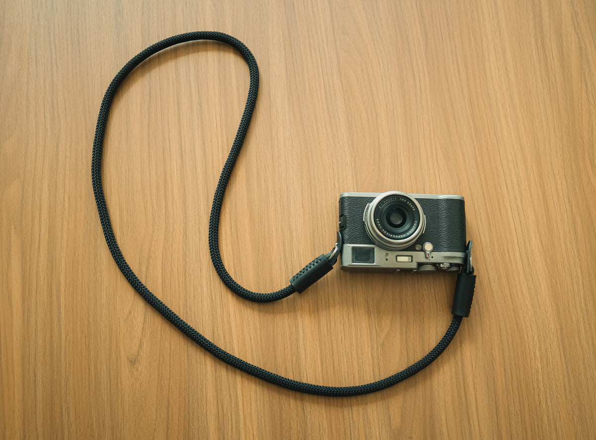 black camera strap with buffalo leather detail