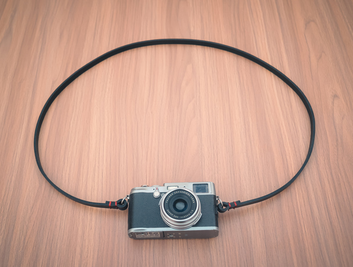 Leather strap attachment with metal split rings for a camera