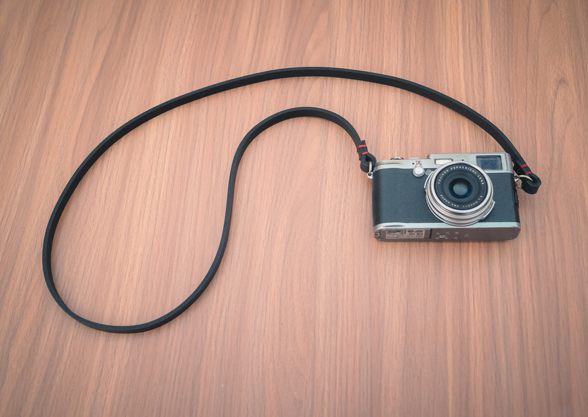 Finished leather edges on the handmade black camera strap