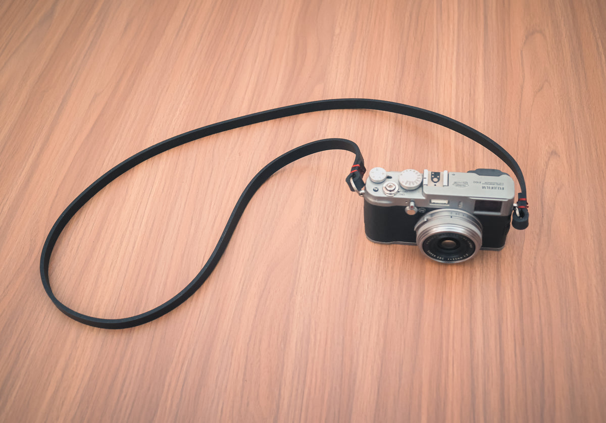 Hand-stitched detail on a black leather camera strap