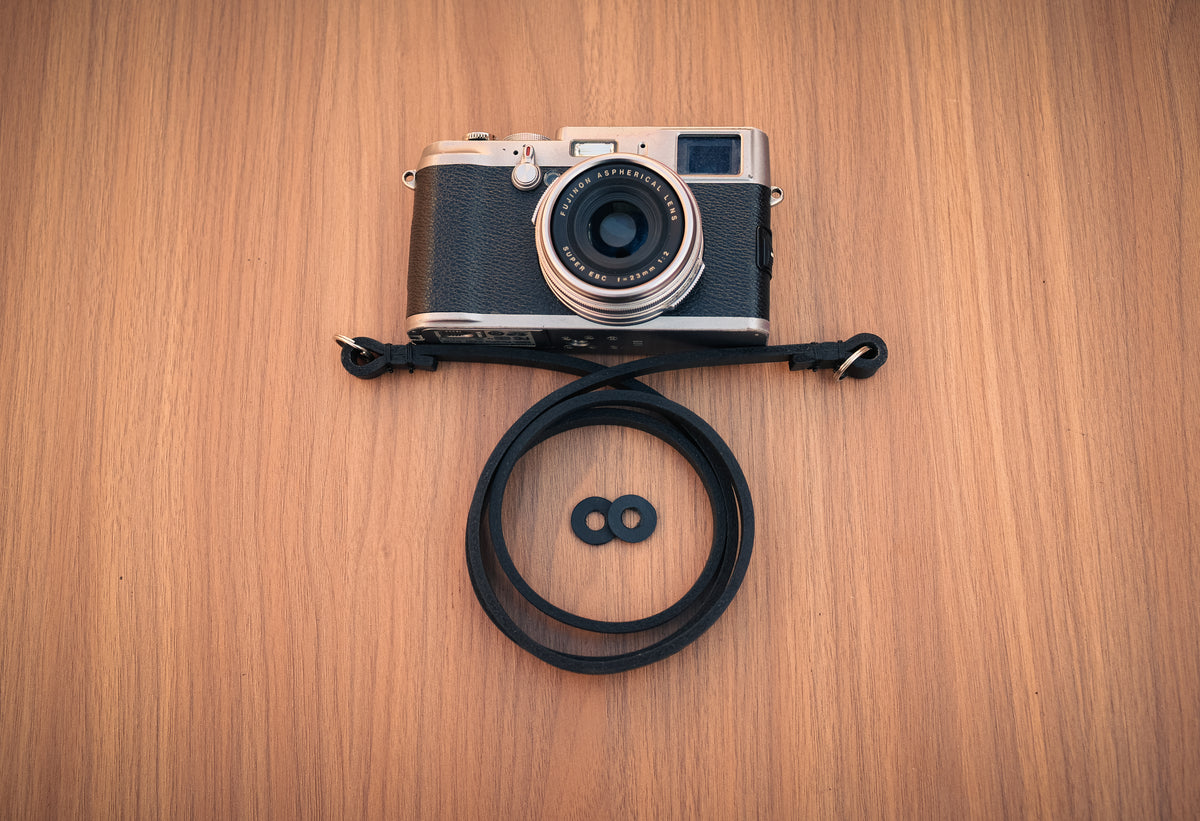 Adjustable-length black leather camera strap for everyday photography