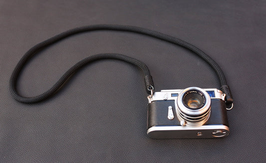 Black leather camera strap end with black stitching