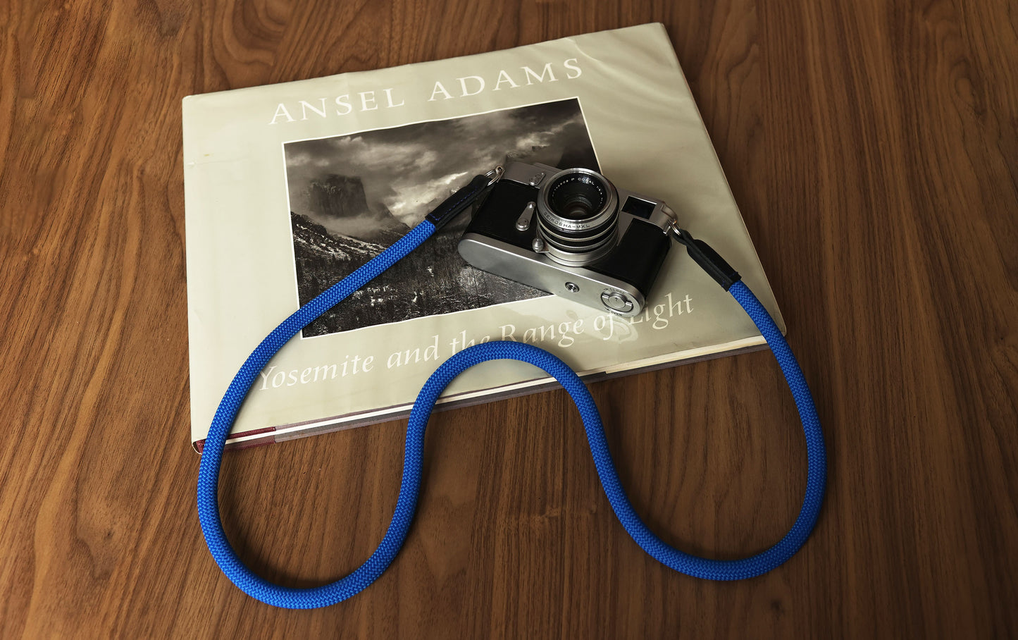 Blue rope camera strap paired with a vintage film camera