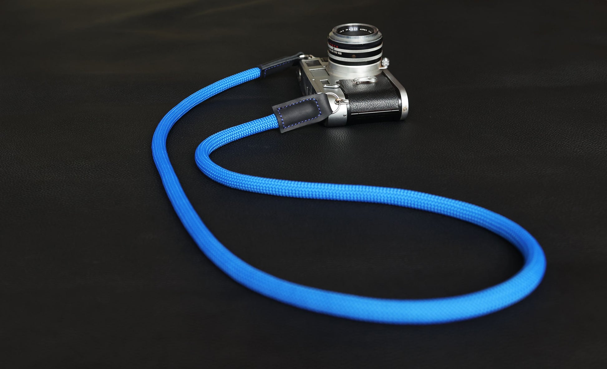 Handmade blue climbing rope camera strap with black matte leather ends