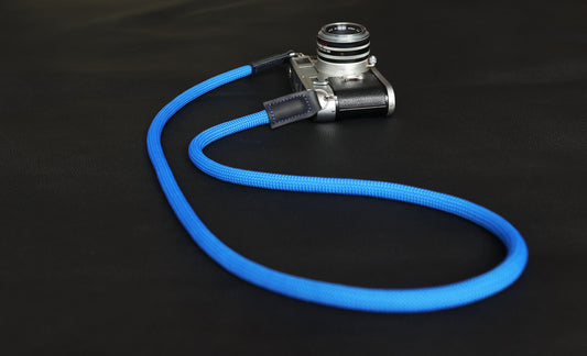 Handmade blue climbing rope camera strap with black matte leather ends