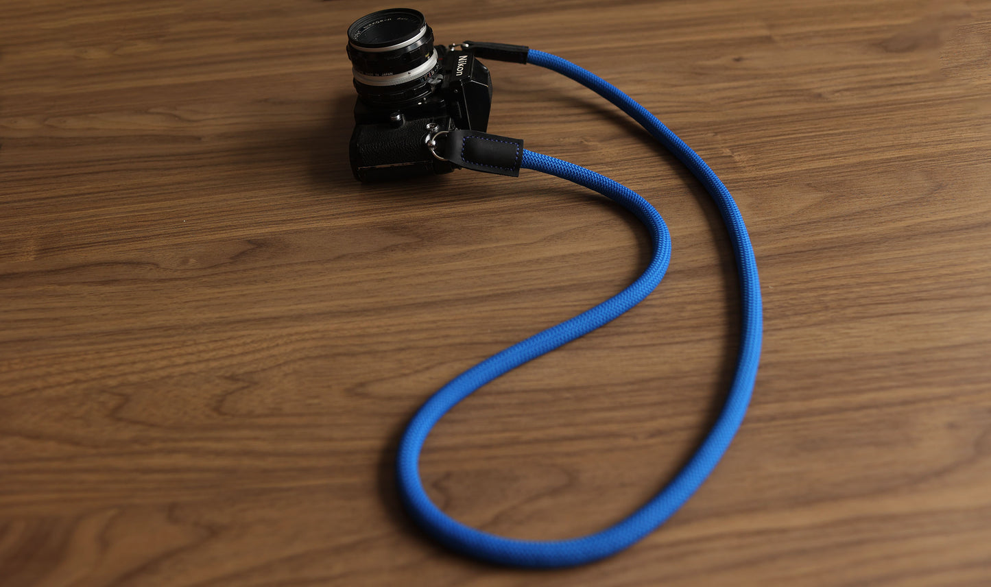 Blue climbing rope strap with black matte leather tabs