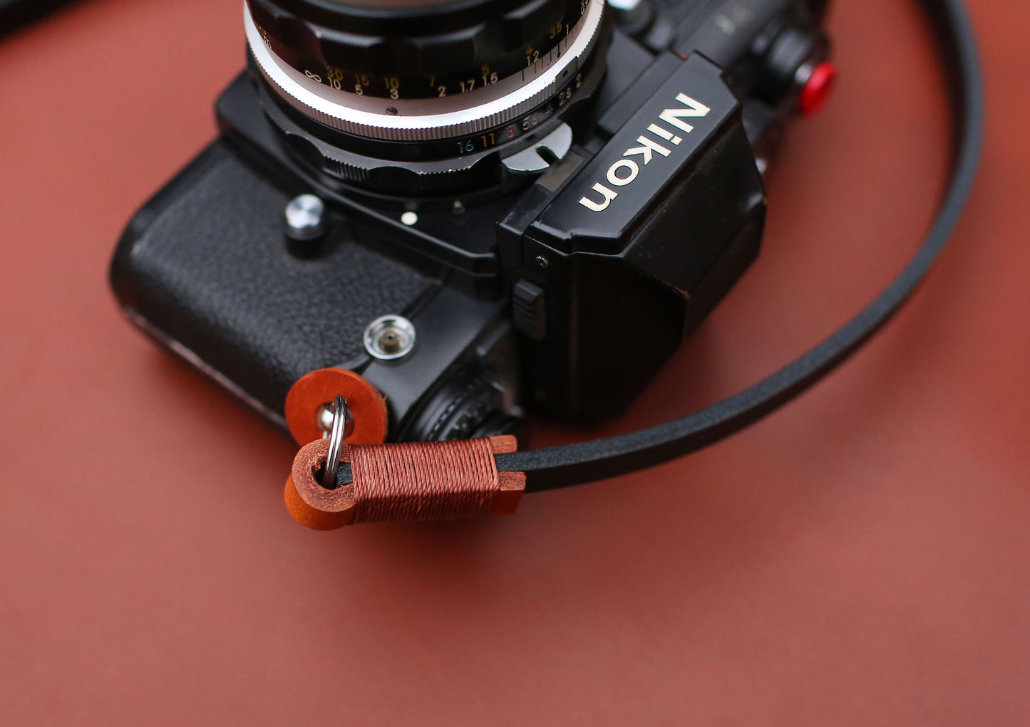 Vegetable-tanned camera strap ends with wax thread