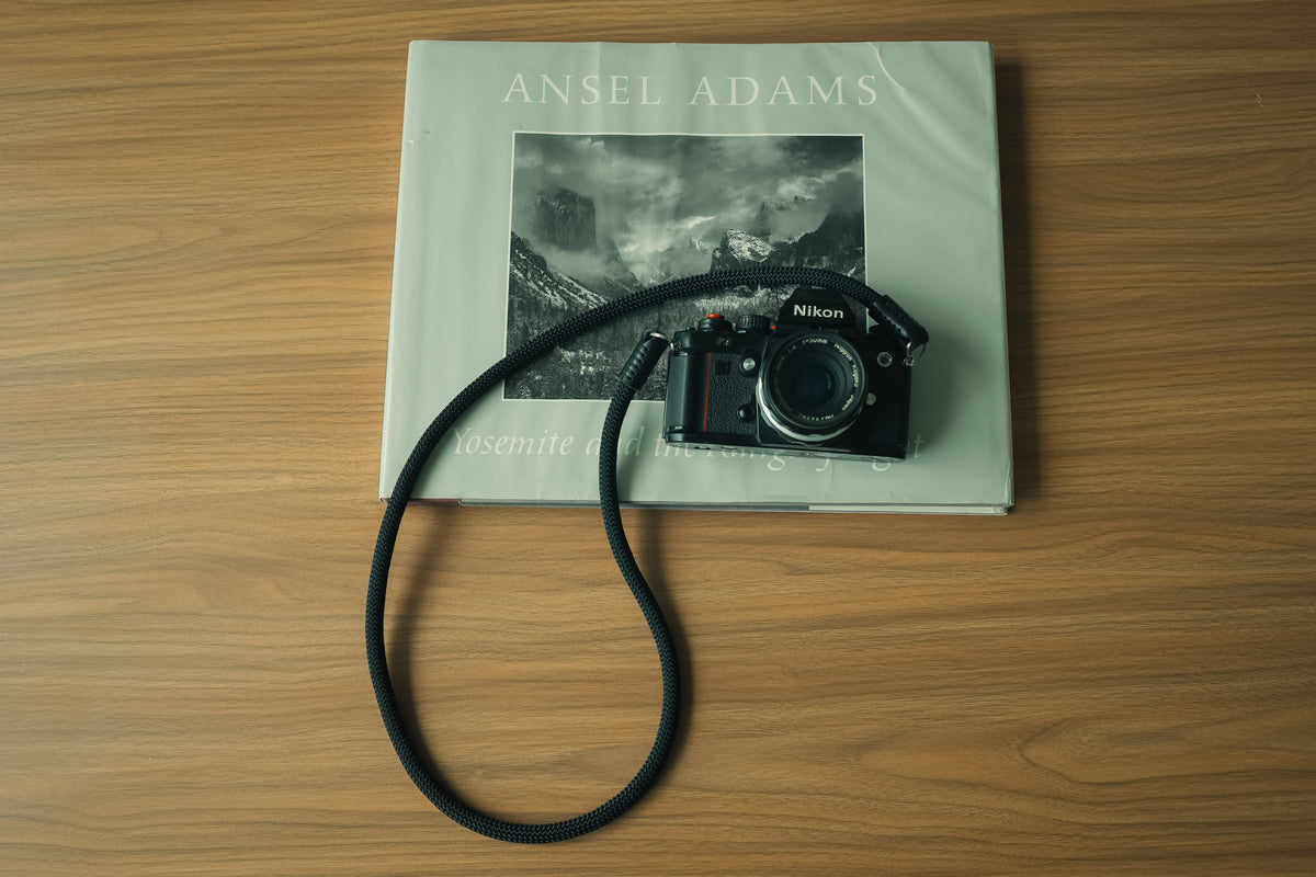 Compact black leather connection design on a rope camera strap