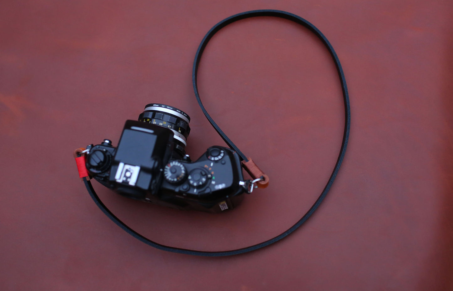Black and tan leather strap on film camera