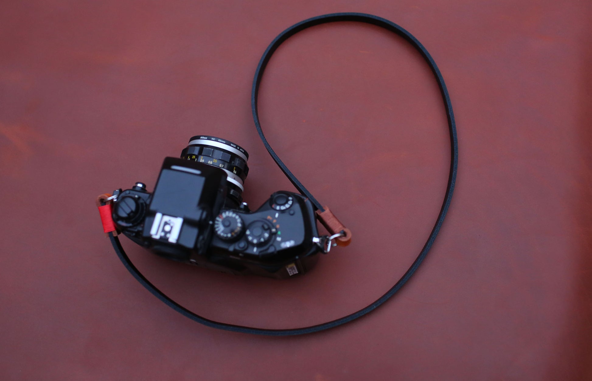 Black and tan leather strap on film camera