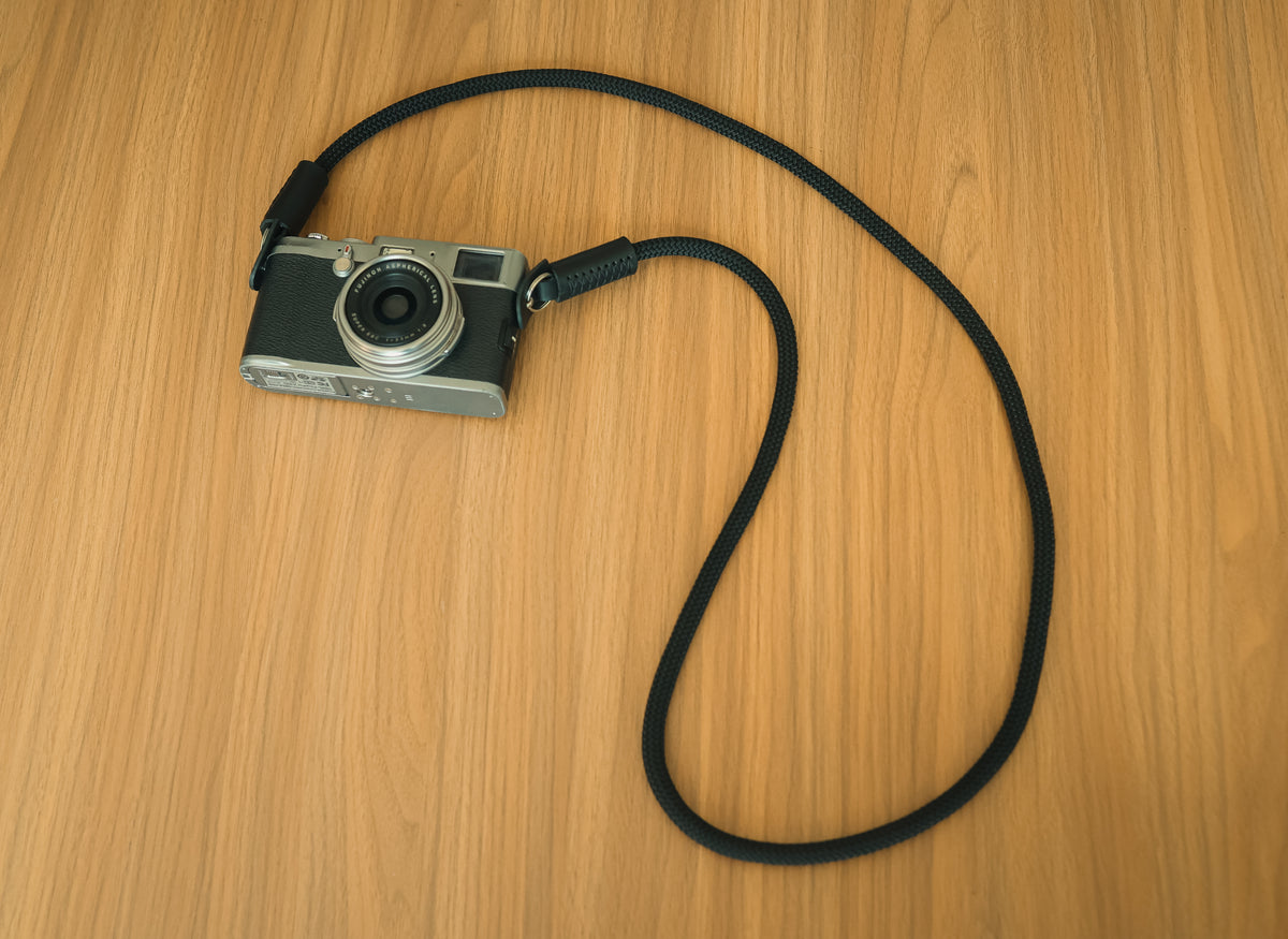 cylindrical leather ends on handmade camera strap