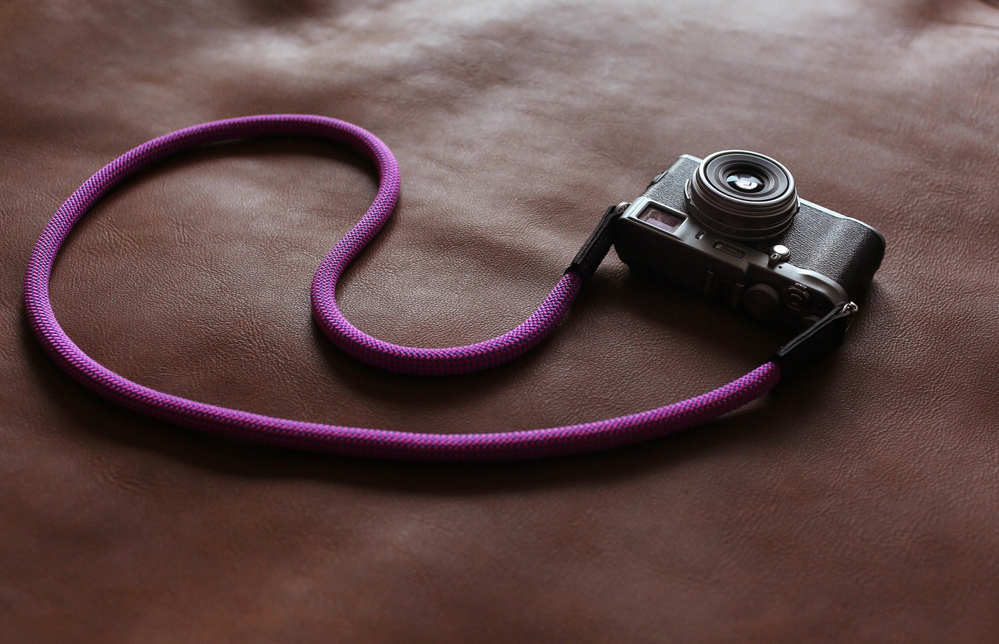 Lifestyle shot of Windmup camera strap on table