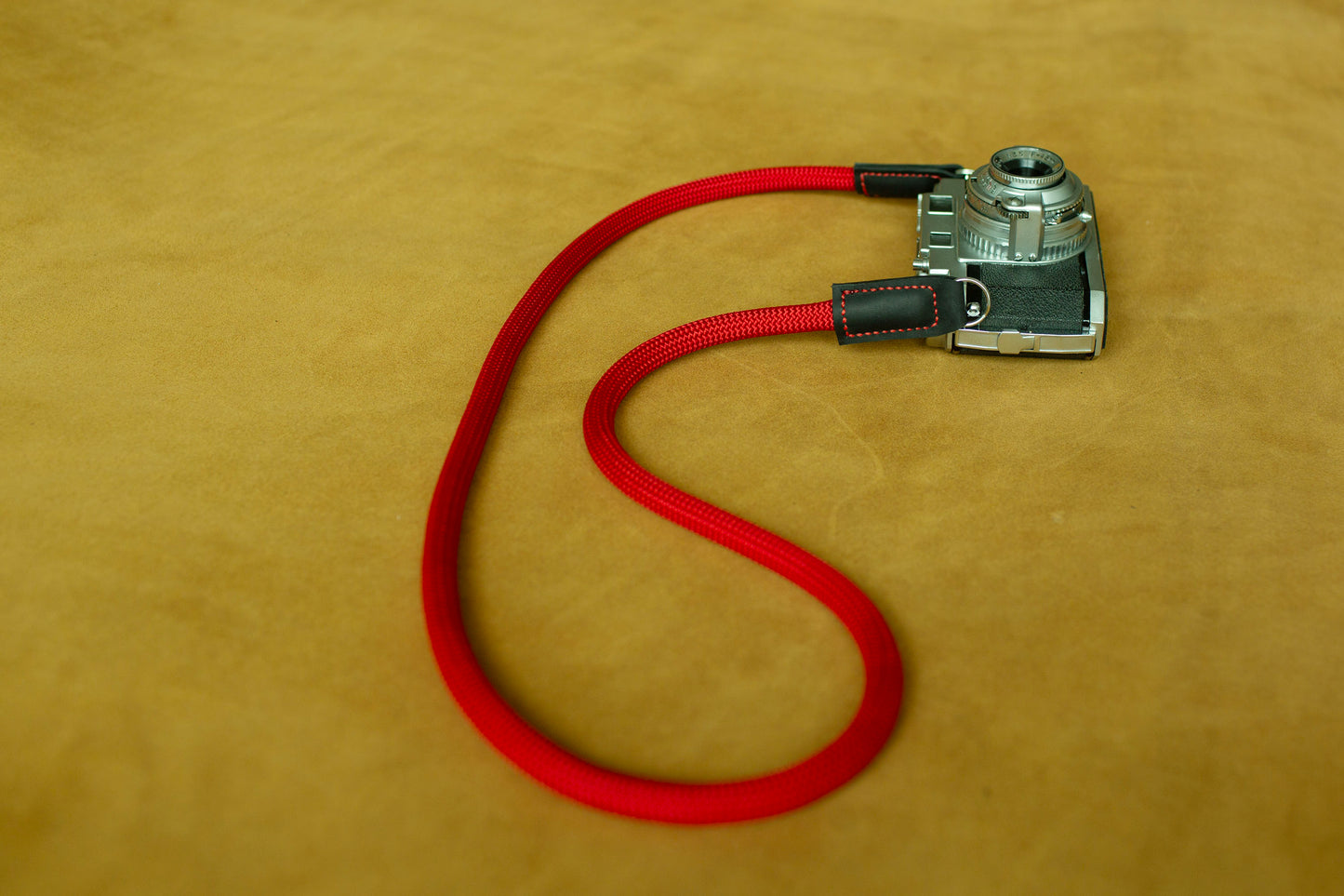 Durable red nylon climbing rope camera neck strap featuring reinforced leather stitching