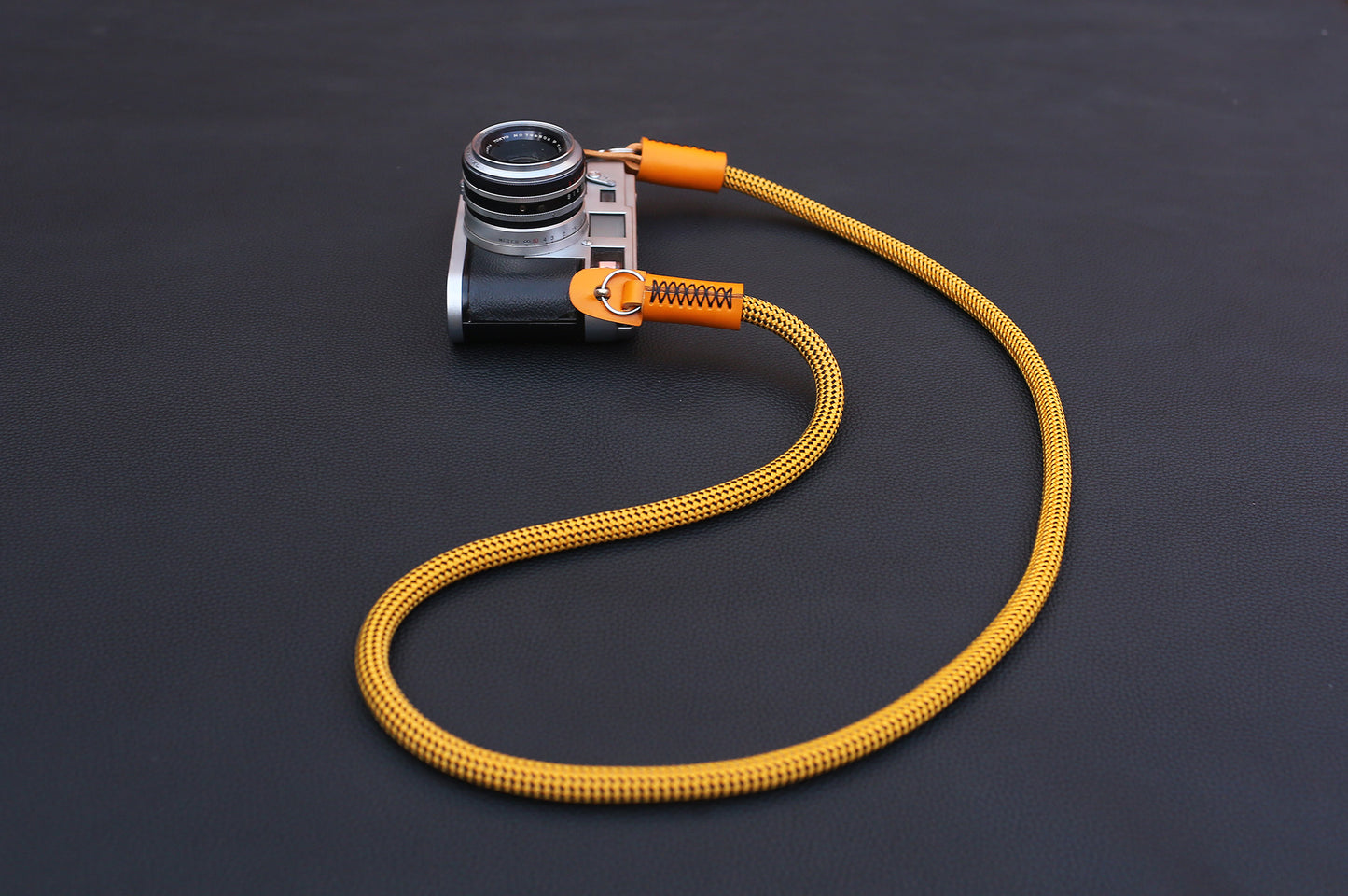 Texture detail of gold climbing rope camera strap
