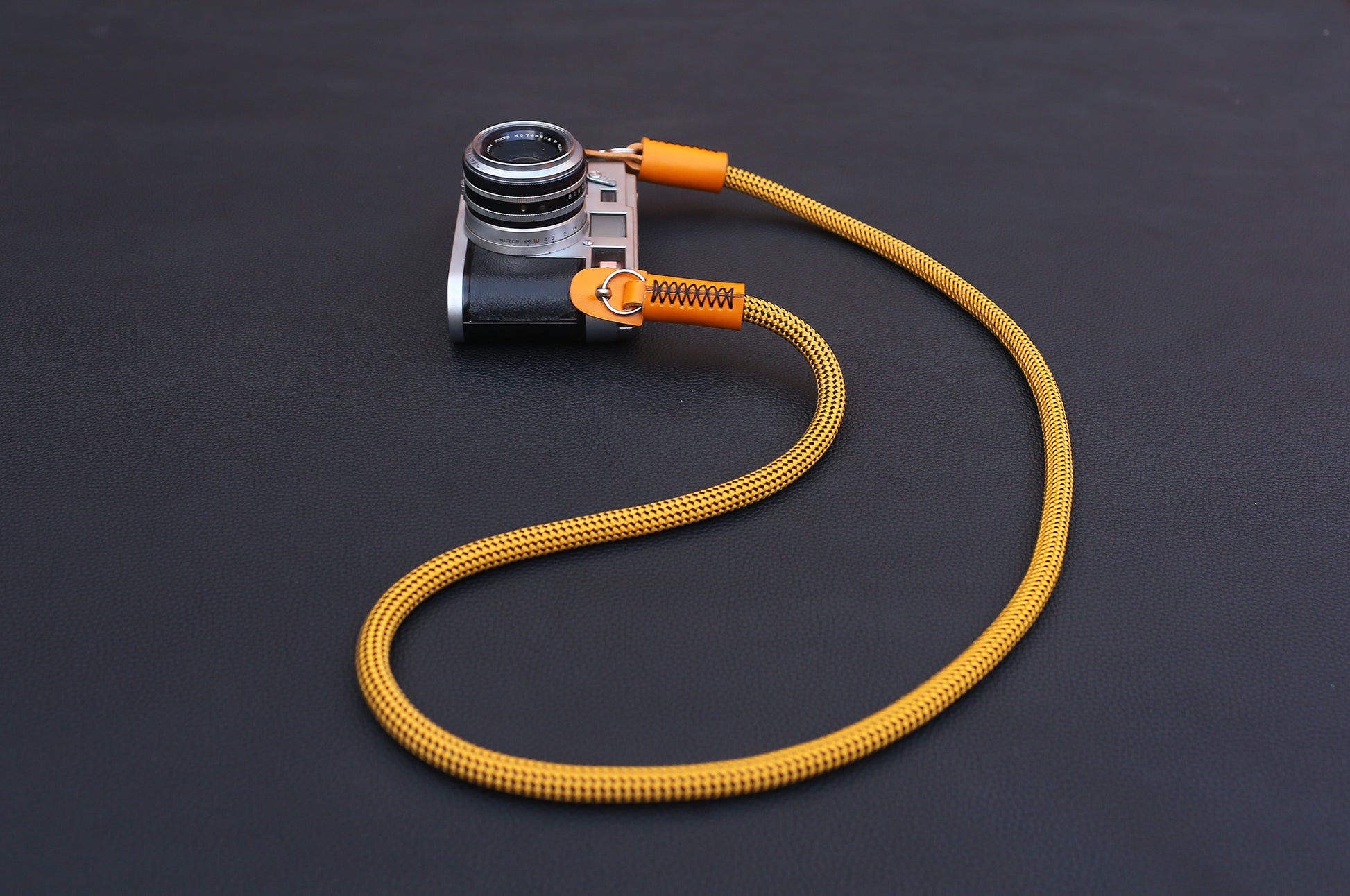 Texture detail of gold climbing rope camera strap