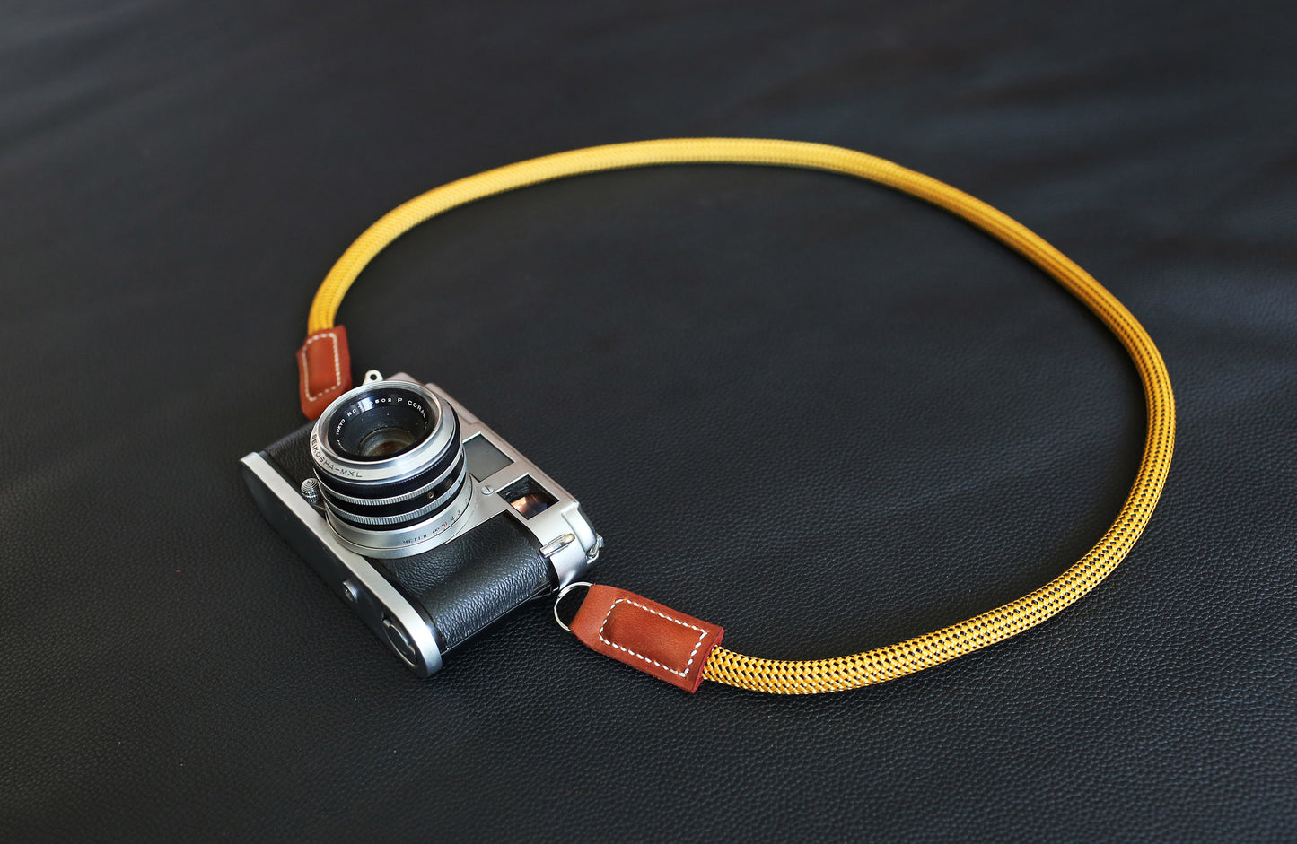 Close-up of Windmup Gold climbing rope camera strap with Brown matte leather detail