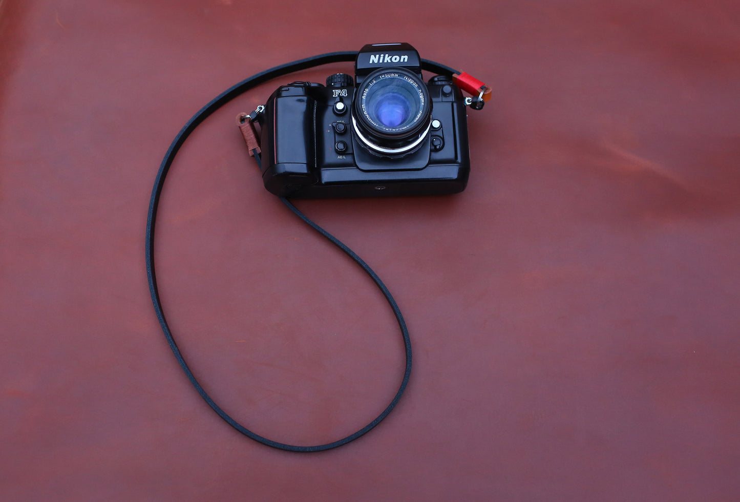 Camera strap detail showing wax stitching