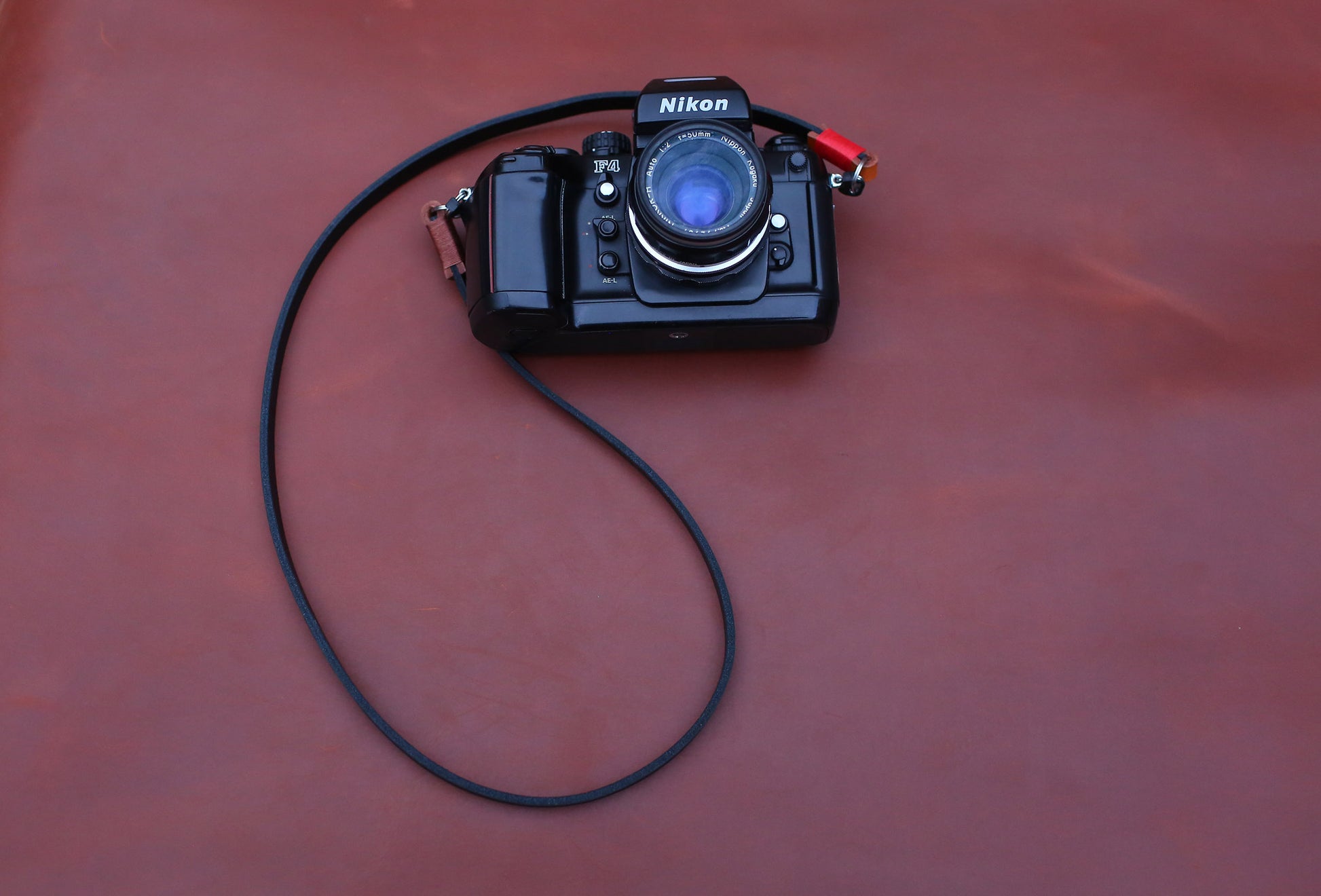 Camera strap detail showing wax stitching