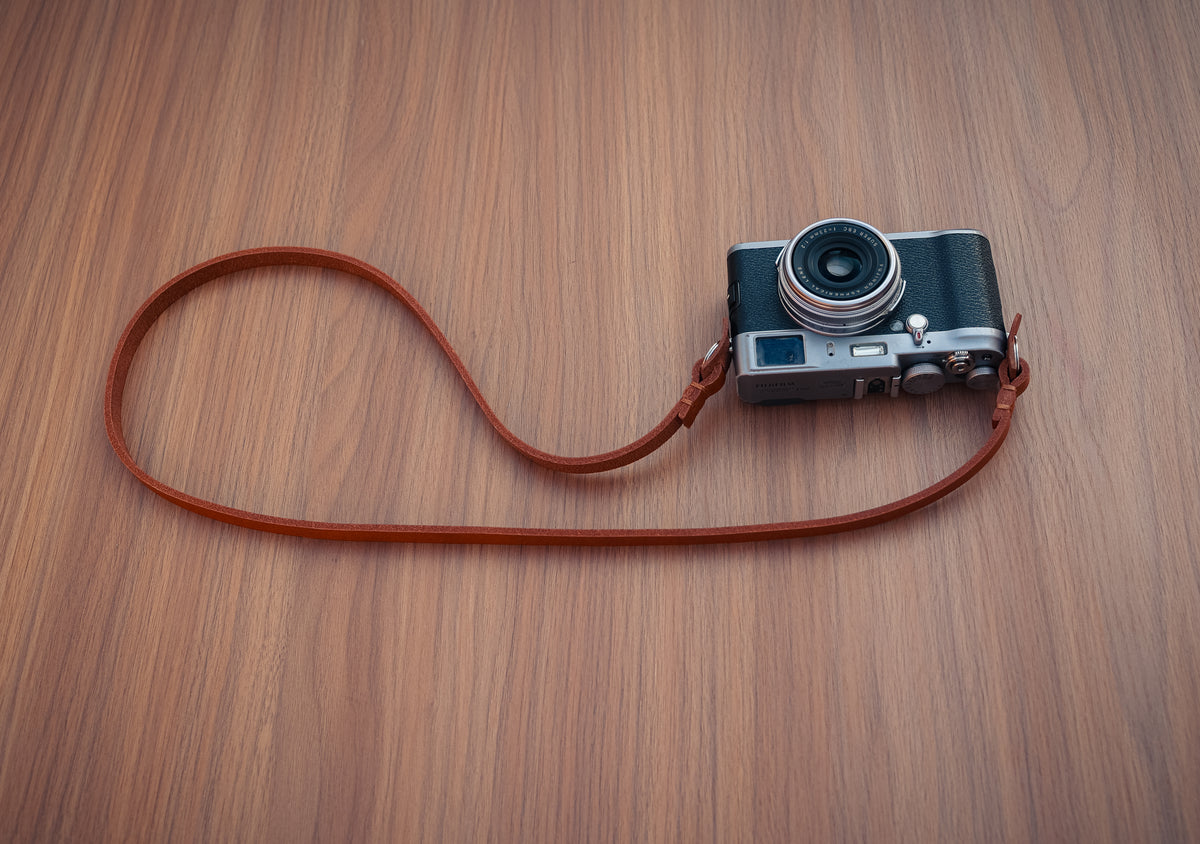 Hand-stitched details on a handmade leather camera strap
