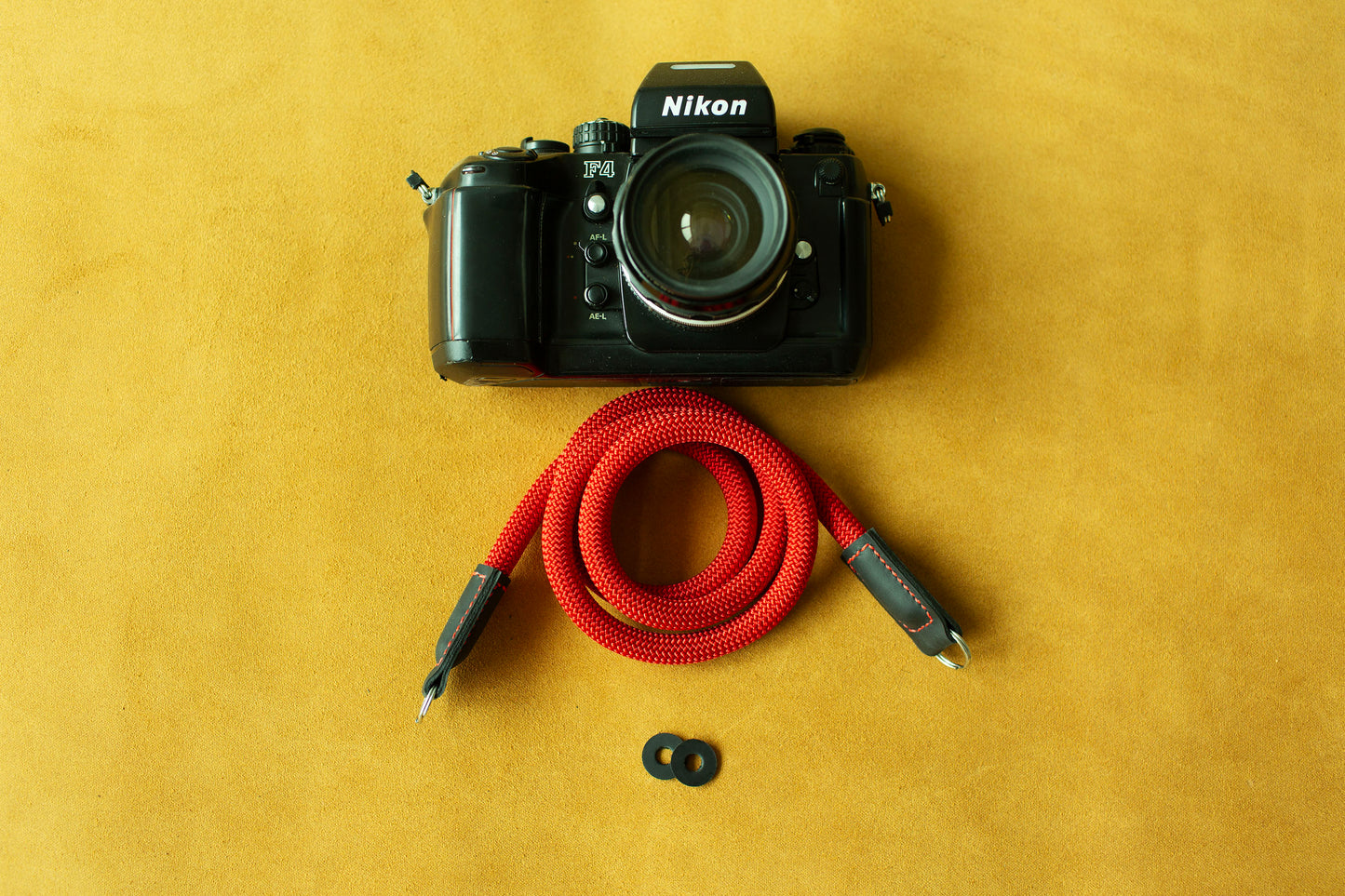 Handcrafted red climbing rope camera strap showcasing artisanal leather workmanship