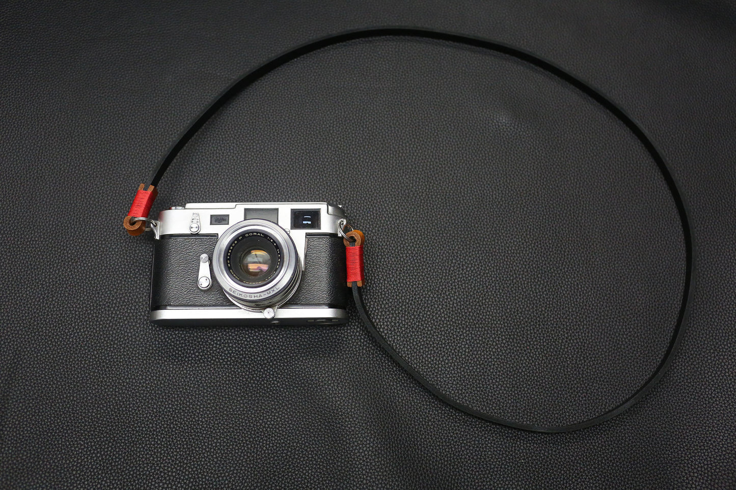 Vintage rangefinder camera with Windmup black leather strap attached.
