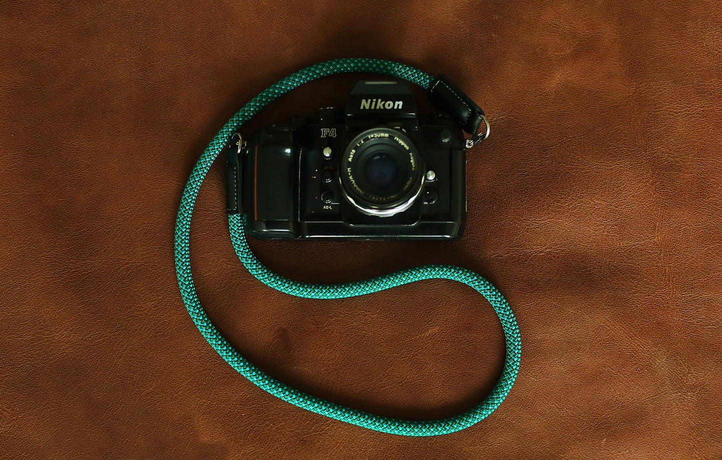 Green and blue woven rope strap displayed with camera gear setup