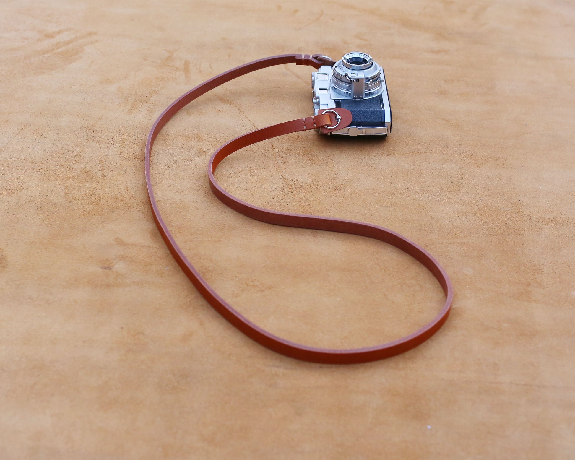 Handcrafted genuine brown leather camera strap for vintage film cameras.