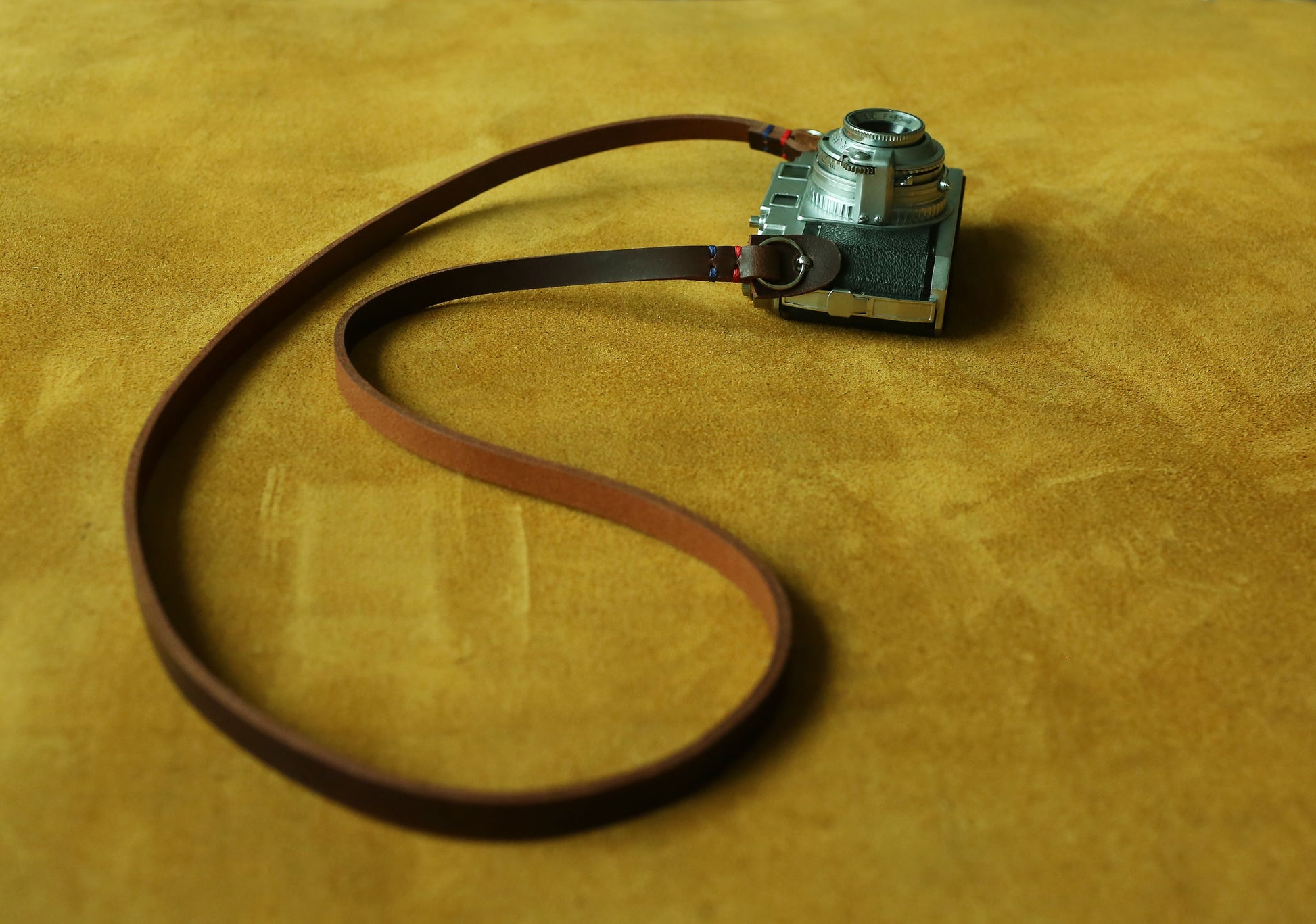 Handmade leather camera strap in rugged tan brown color