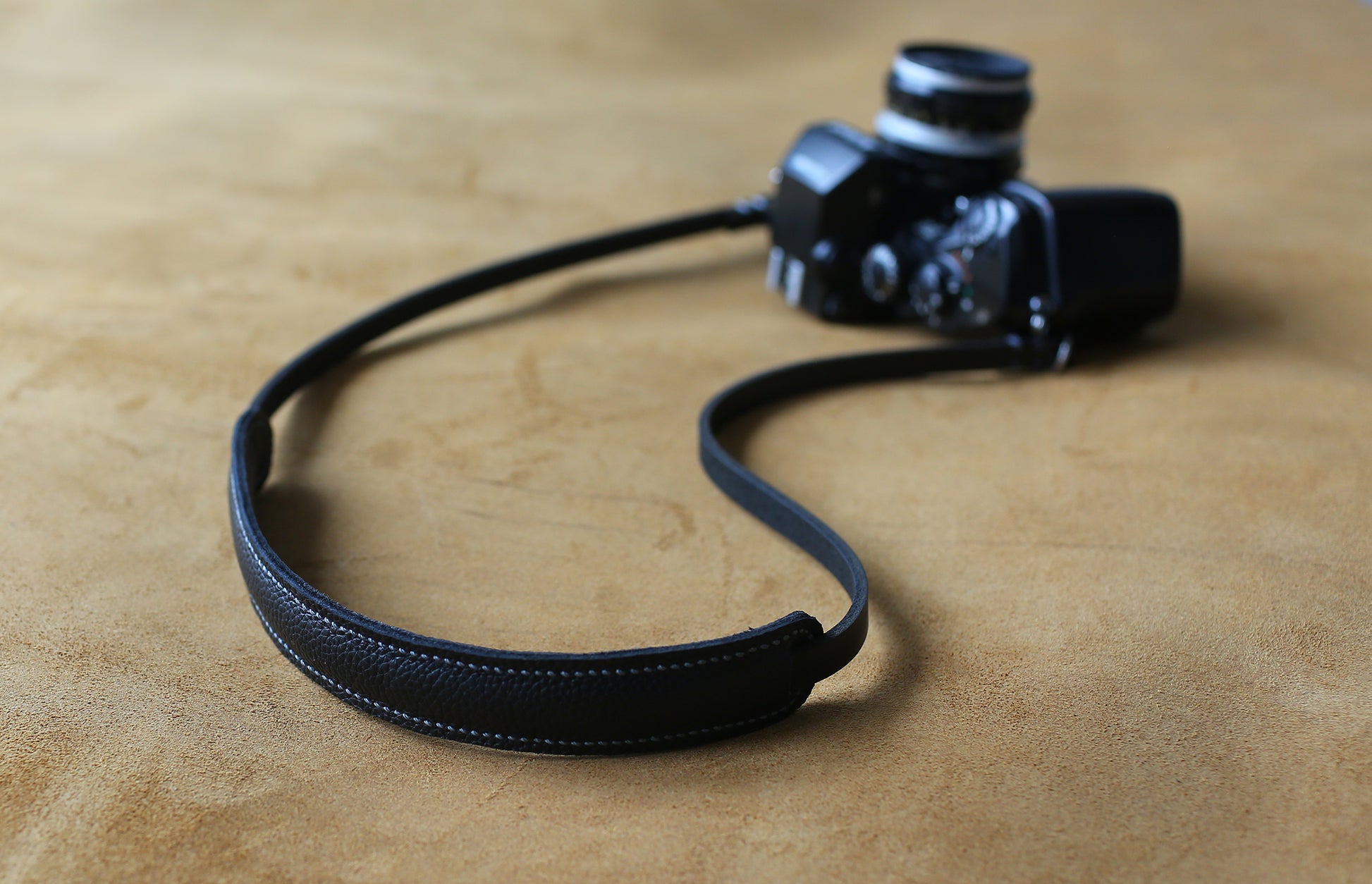 Black leather strap with grey stitching details